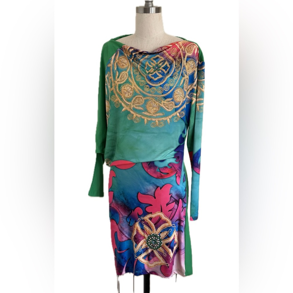 Colorful embroidered dress, vibrant patterns, long sleeves, jewel detail.